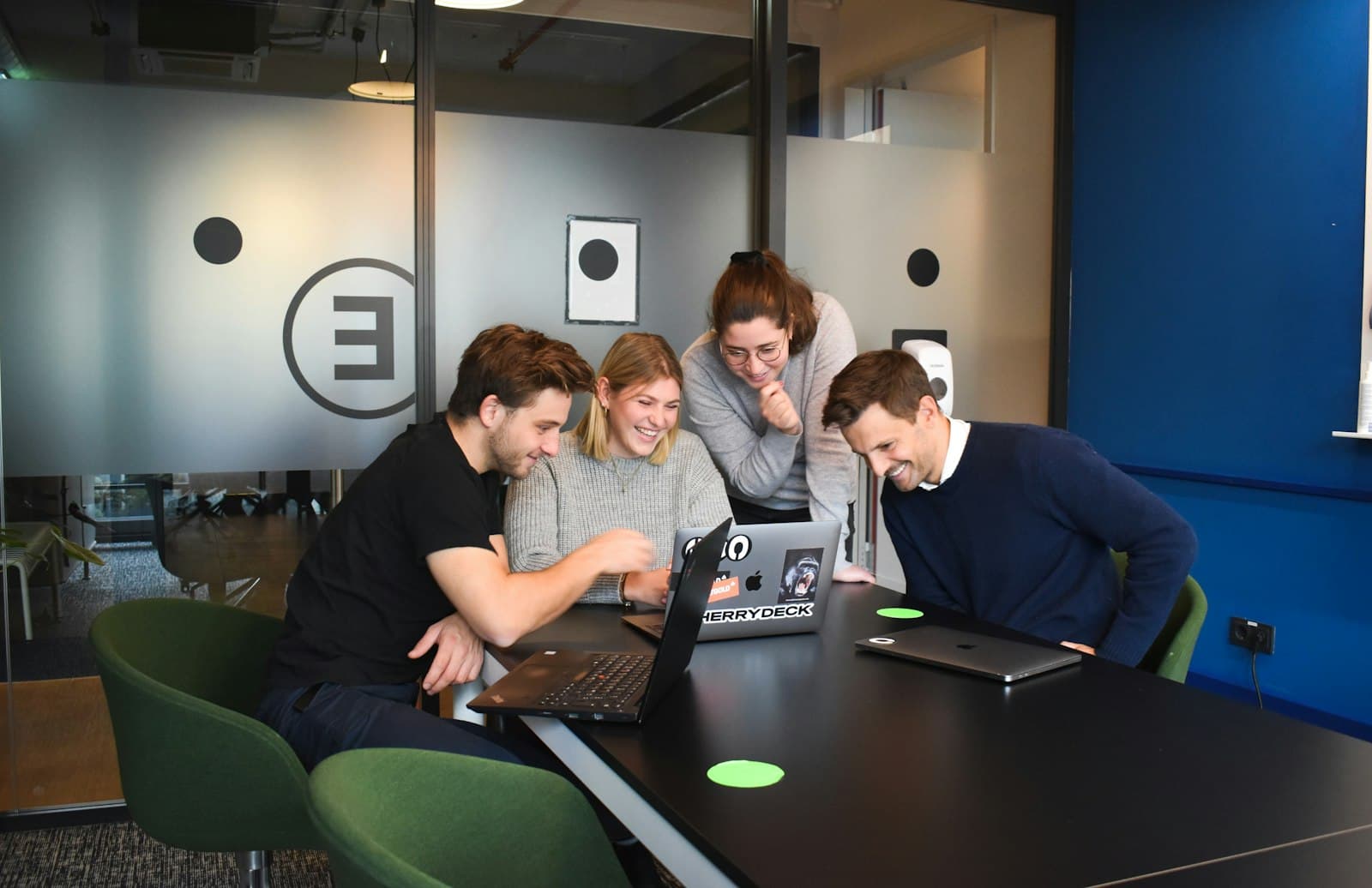 People working on laptops at a shared table