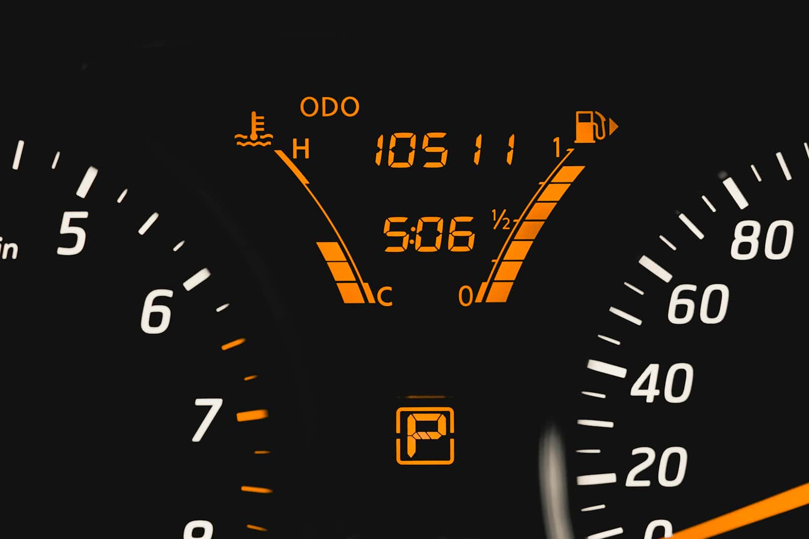 A car instrument cluster lit at night